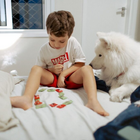 Un bambino gioca con il suo cane: la pet therapy porta normalità in ospedale 